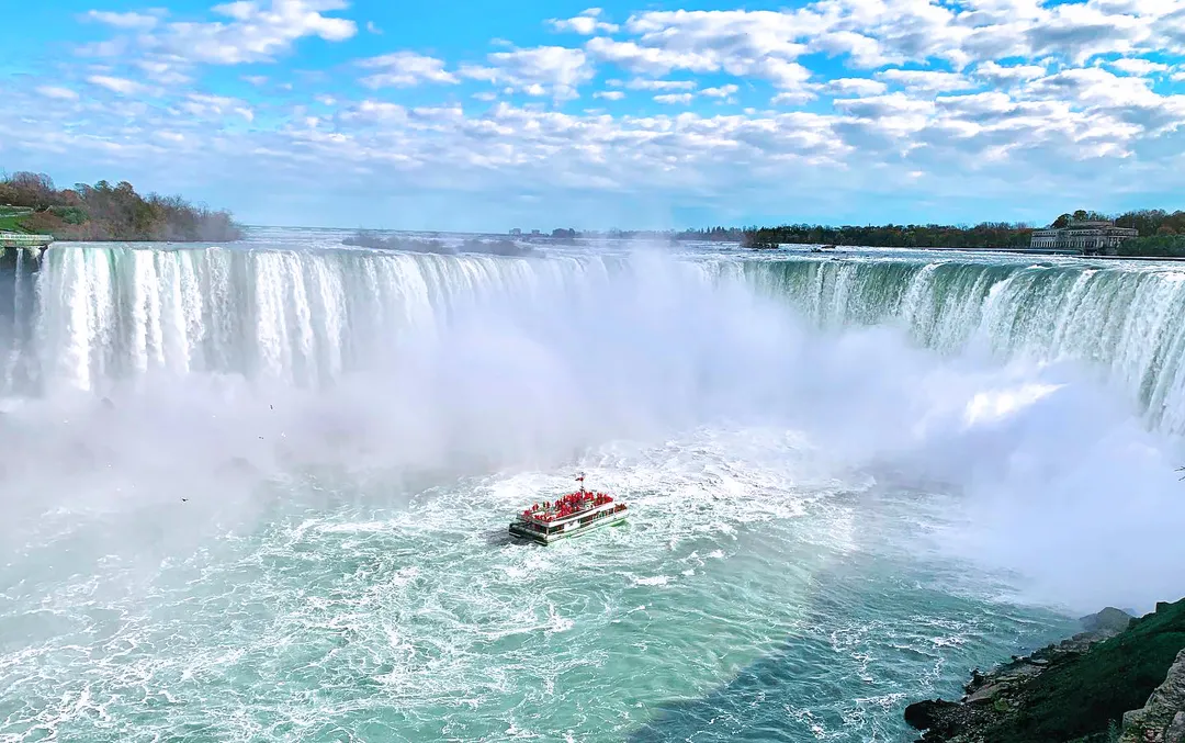 Niagara City Cruises Voyage to the Falls boat completely surrounded by the powerful mist and spray of Horseshoe Falls during the ultimate boat cruise experience