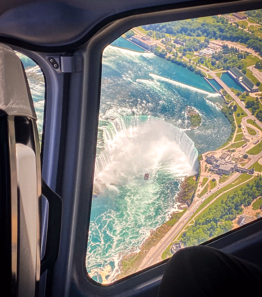 Stunning aerial view of Niagara Falls from helicopter showing all three falls