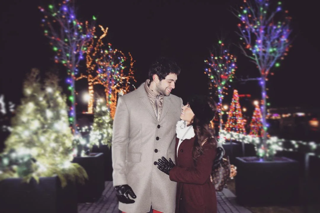 Couple hugging while viewing Winter Festival of Lights displays
