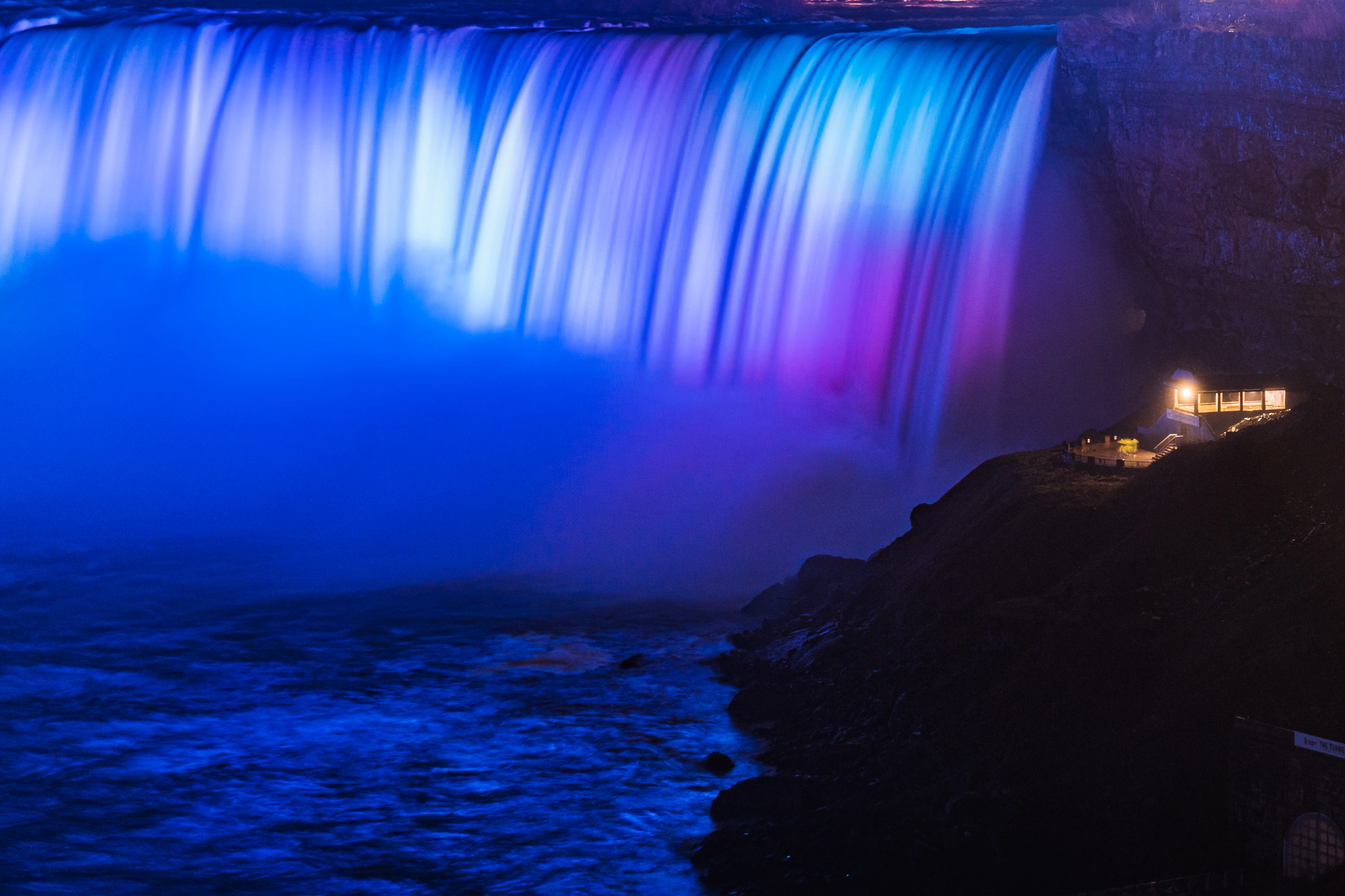 Journey Behind the Falls viewing portal with purple illuminated Niagara Falls during Winter Festival of Lights