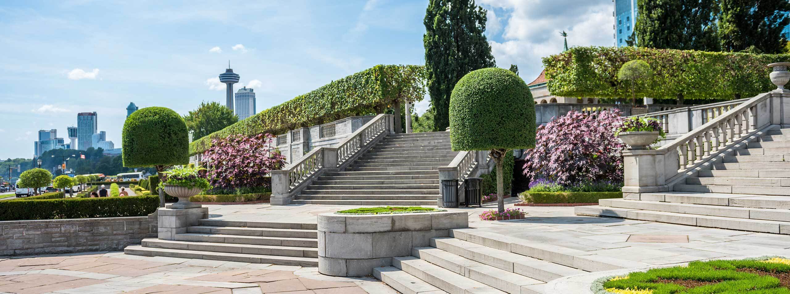Lush seasonal floral displays and garden pathways at Oakes Garden Theatre with waterfall backdrops